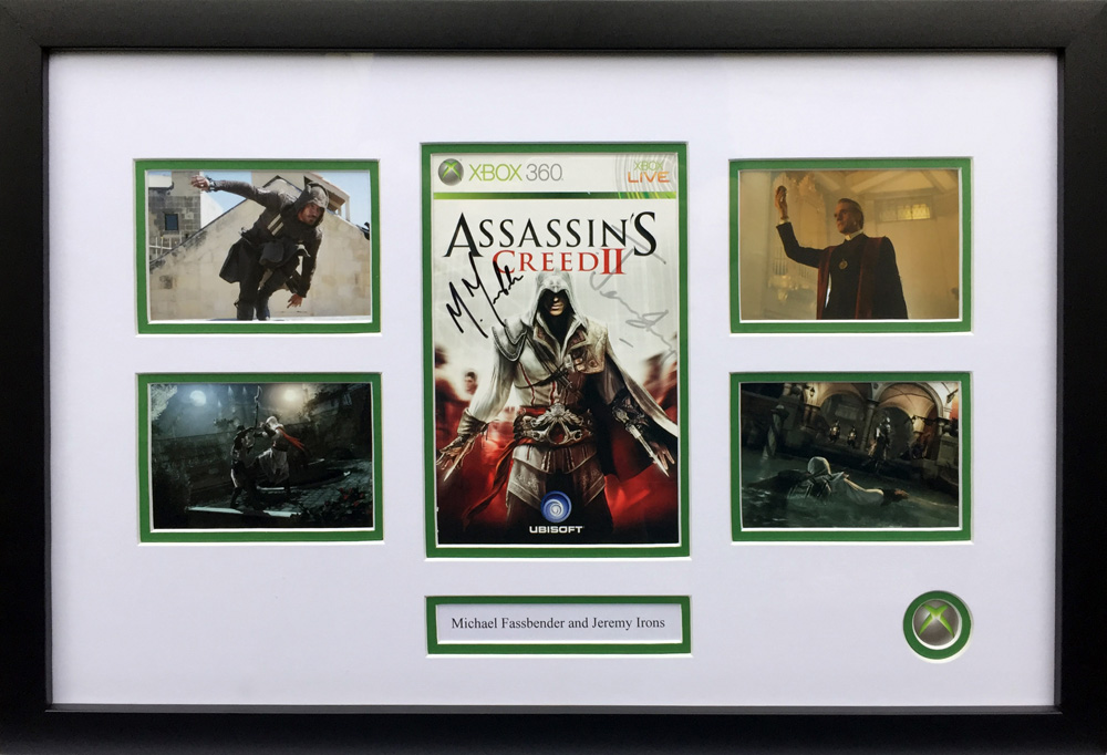 Framed Assassins Creed II Game Cover Signed by Michael Fassbender & Jeremy Irons